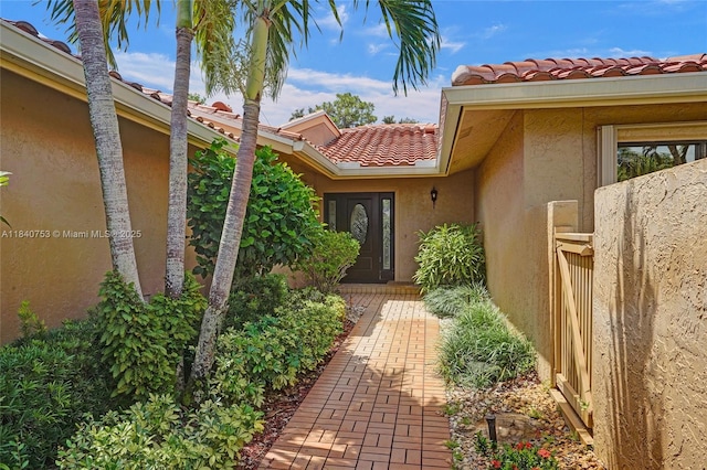 53 Northwoods Ln, Boynton Beach, FL 33436 - entrance to property featuring a tile roof and stucco siding
