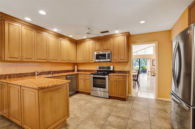 53 Northwoods Ln, Boynton Beach, FL 33436 - kitchen with stainless steel appliances, a peninsula, recessed lighting, dark stone countertops, and light tile patterned floors