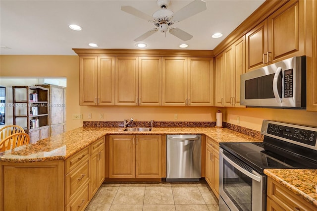 53 Northwoods Ln, Boynton Beach, FL 33436 - kitchen featuring appliances with stainless steel finishes, a peninsula, recessed lighting, light stone countertops, and ceiling fan