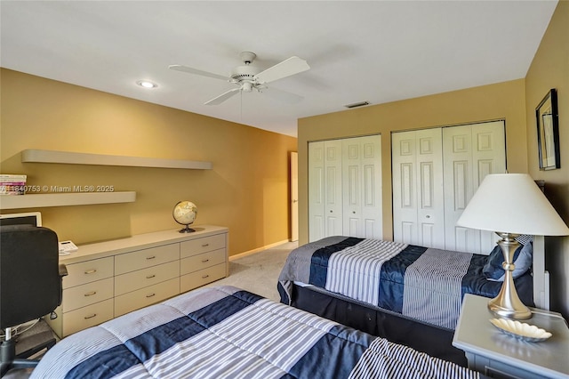 53 Northwoods Ln, Boynton Beach, FL 33436 - bedroom with multiple closets, light carpet, ceiling fan, and a desk