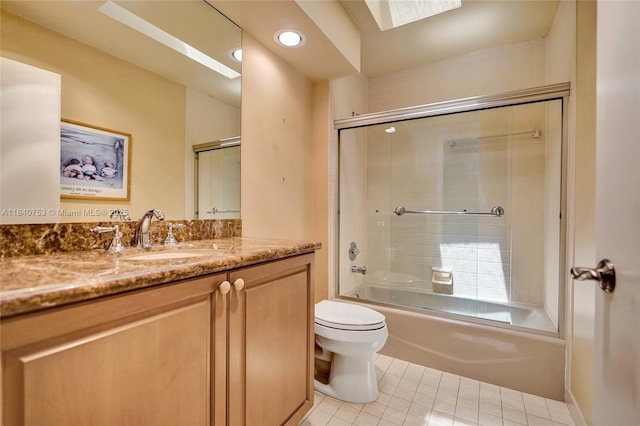 53 Northwoods Ln, Boynton Beach, FL 33436 - bathroom with tile patterned floors, a skylight, vanity, combined bath / shower with glass door, and recessed lighting