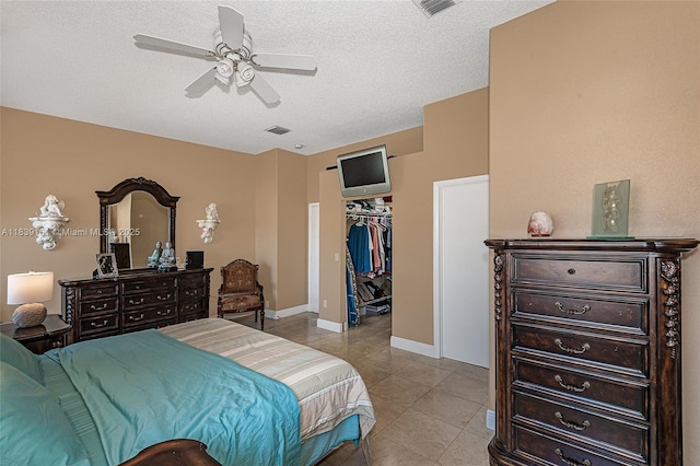 2188 NW 158th Ave, Pembroke Pines, FL 33028 - bedroom featuring light tile patterned floors, a textured ceiling, a walk in closet, and ceiling fan