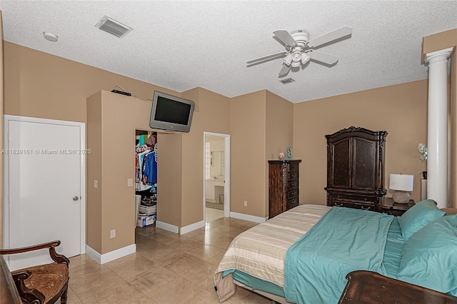 2188 NW 158th Ave, Pembroke Pines, FL 33028 - bedroom with a textured ceiling, a walk in closet, light tile patterned flooring, decorative columns, and ensuite bath