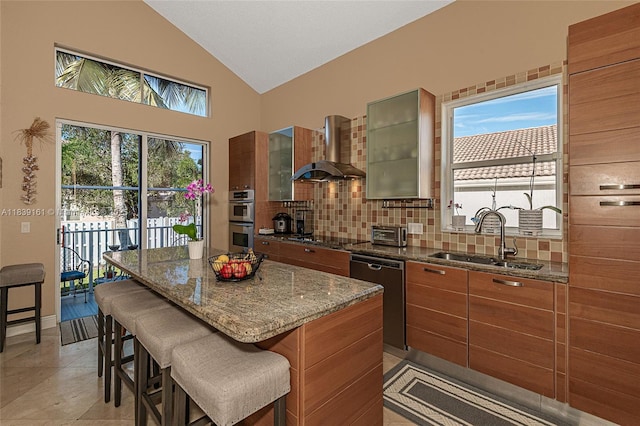 2188 NW 158th Ave, Pembroke Pines, FL 33028 - kitchen featuring wall chimney range hood, vaulted ceiling, backsplash, a breakfast bar, and brown cabinetry