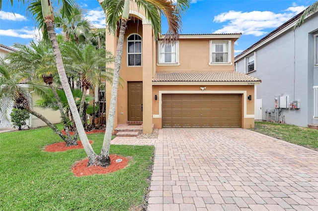 3758 SW 50th Ct, Hollywood, FL 33312 - mediterranean / spanish house with decorative driveway, stucco siding, an attached garage, a front yard, and a tiled roof