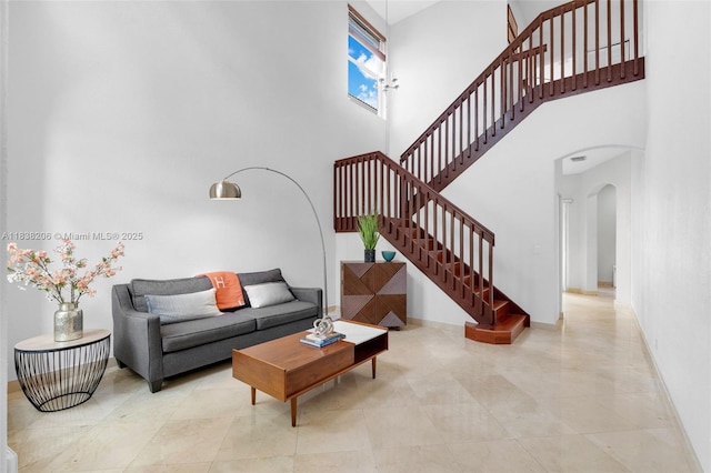 3758 SW 50th Ct, Hollywood, FL 33312 - living room featuring arched walkways, a high ceiling, and stairway