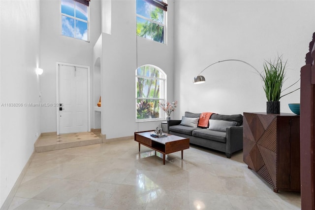 3758 SW 50th Ct, Hollywood, FL 33312 - living area with healthy amount of natural light, a high ceiling, and arched walkways
