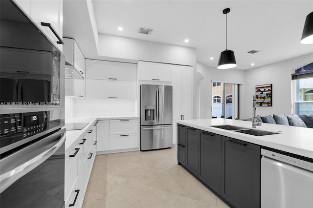 3758 SW 50th Ct, Hollywood, FL 33312 - kitchen with appliances with stainless steel finishes, white cabinets, light countertops, decorative light fixtures, and recessed lighting
