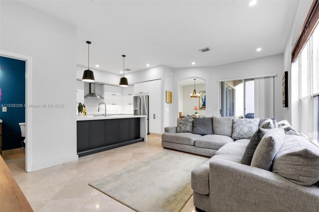 3758 SW 50th Ct, Hollywood, FL 33312 - living room with recessed lighting, a chandelier, arched walkways, and light tile patterned floors