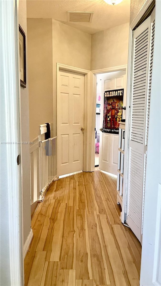 9087 SW 153rd Ct, Miami, FL 33196 - corridor featuring light wood finished floors and attic access