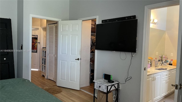 9087 SW 153rd Ct, Miami, FL 33196 - bedroom with light wood-style floors, a closet, and connected bathroom