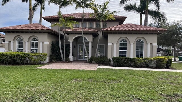 9087 SW 153rd Ct, Miami, FL 33196 - view of front of home featuring french doors, stucco siding, a front yard, and a tile roof