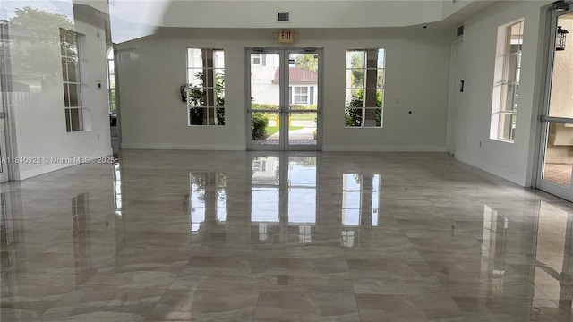 9087 SW 153rd Ct, Miami, FL 33196 - empty room with marble tiled floors and french doors