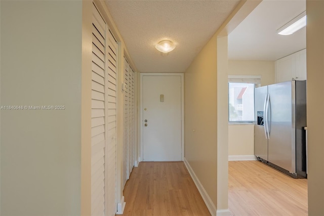 3581 Inverrary Dr Unit 308, Lauderhill, FL 33319 - hall featuring light wood finished floors and a textured ceiling