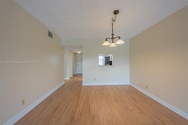 3581 Inverrary Dr Unit 308, Lauderhill, FL 33319 - unfurnished room featuring light wood-type flooring, a textured ceiling, and a chandelier