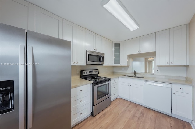3581 Inverrary Dr Unit 308, Lauderhill, FL 33319 - kitchen featuring appliances with stainless steel finishes, light wood-type flooring, and white cabinetry