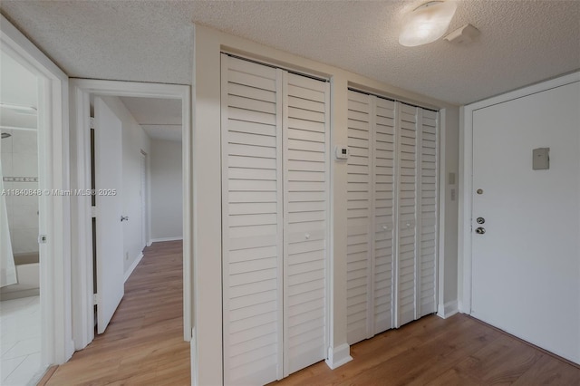 3581 Inverrary Dr Unit 308, Lauderhill, FL 33319 - corridor with light wood-style flooring and a textured ceiling