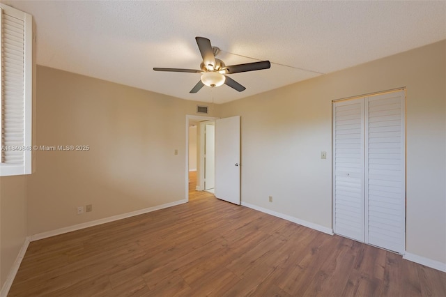3581 Inverrary Dr Unit 308, Lauderhill, FL 33319 - unfurnished bedroom with wood finished floors, a ceiling fan, and a closet