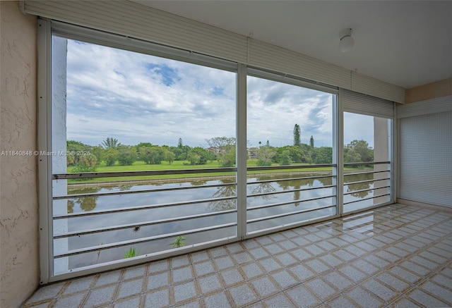 3581 Inverrary Dr Unit 308, Lauderhill, FL 33319 - unfurnished sunroom featuring a water view, healthy amount of natural light, and view of wooded area