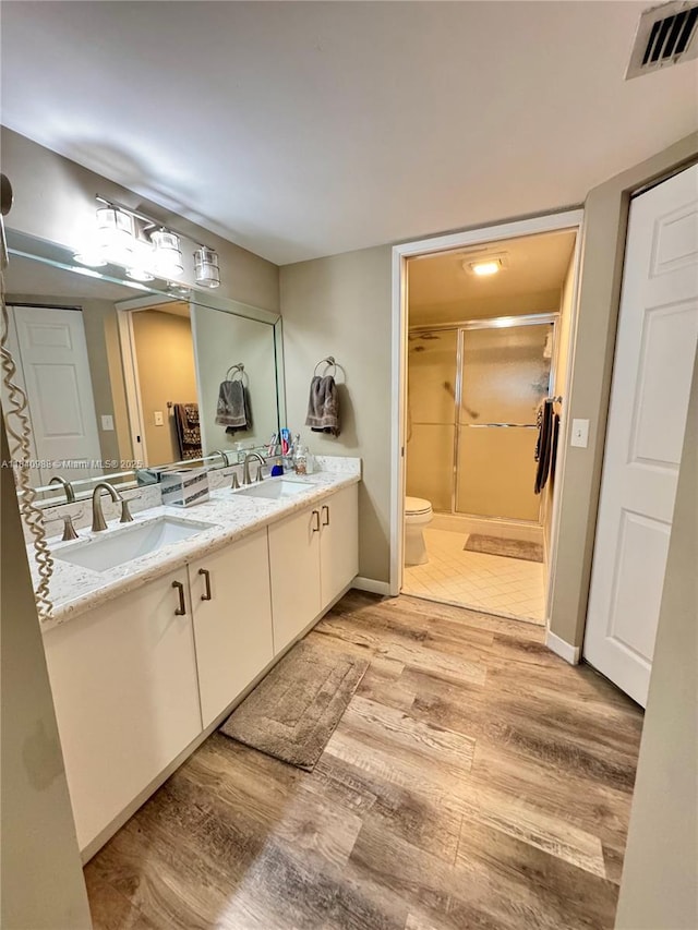 1501 SW 131st Way Unit 301P, Pembroke Pines, FL 33027 - bathroom with wood finished floors, double vanity, and a stall shower