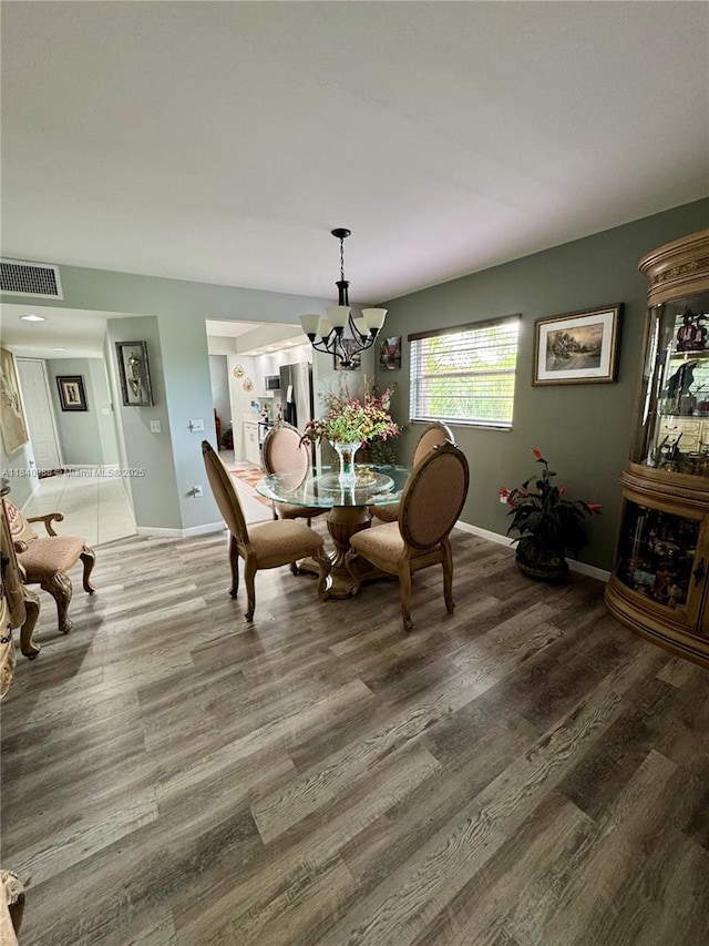 1501 SW 131st Way Unit 301P, Pembroke Pines, FL 33027 - dining room featuring wood finished floors and a chandelier