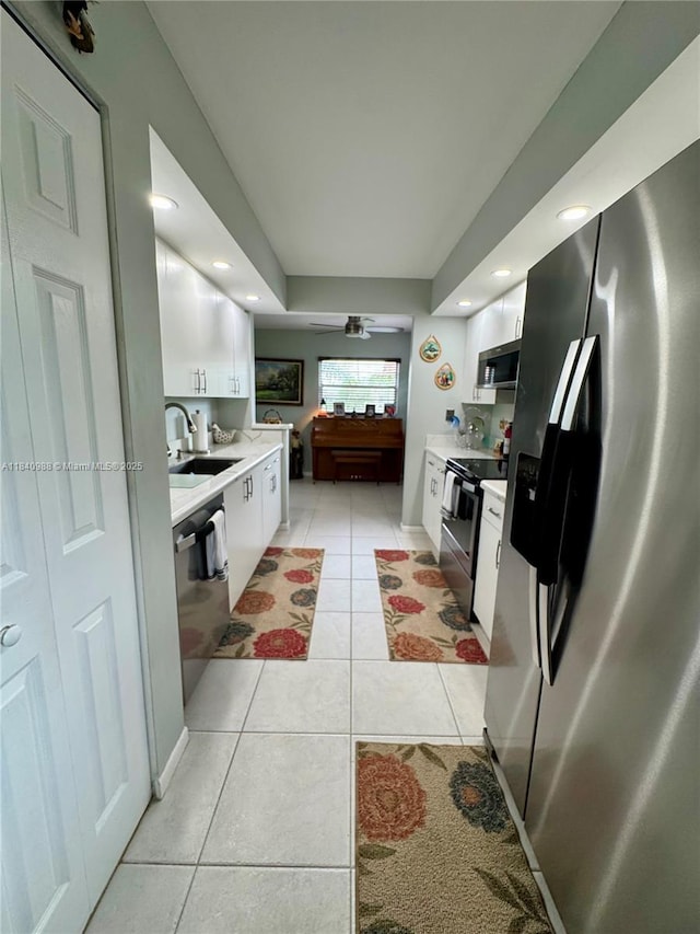 1501 SW 131st Way Unit 301P, Pembroke Pines, FL 33027 - kitchen featuring stainless steel appliances, light countertops, light tile patterned floors, white cabinets, and a ceiling fan