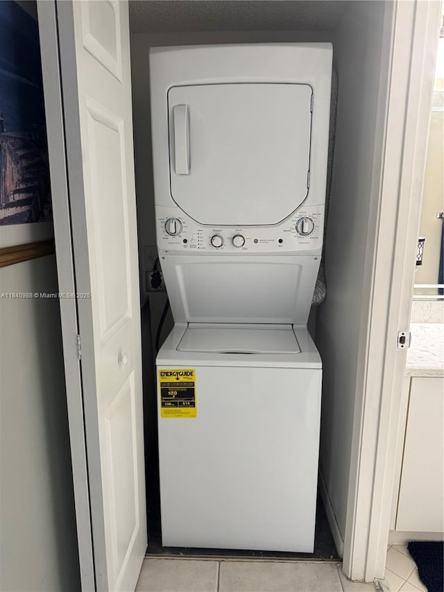 1501 SW 131st Way Unit 301P, Pembroke Pines, FL 33027 - laundry area with stacked washer and clothes dryer and light tile patterned floors