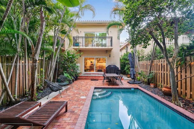 3166 Indiana St Unit I, Miami, FL 33133 - back of property with a balcony, stucco siding, a patio area, and a fenced backyard