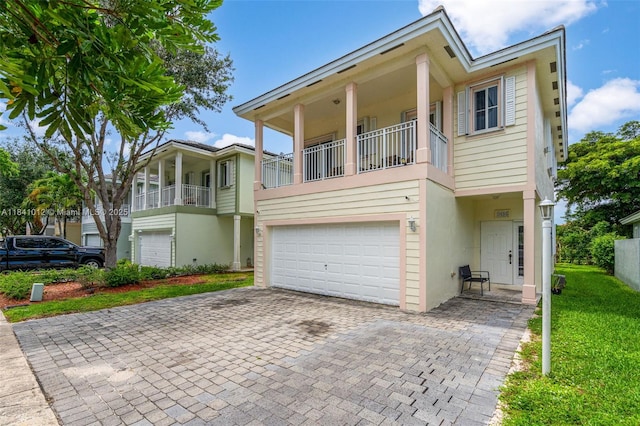 3135 NE 4th St, Homestead, FL 33033 - view of front of home with decorative driveway, a garage, stucco siding, and a front yard