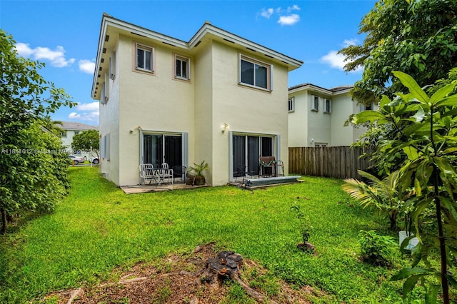 3135 NE 4th St, Homestead, FL 33033 - rear view of house with stucco siding and a patio area