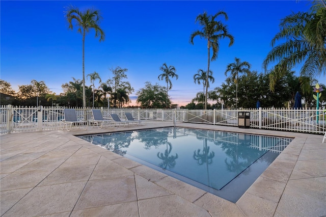 3135 NE 4th St, Homestead, FL 33033 - pool at dusk with a patio and a community pool