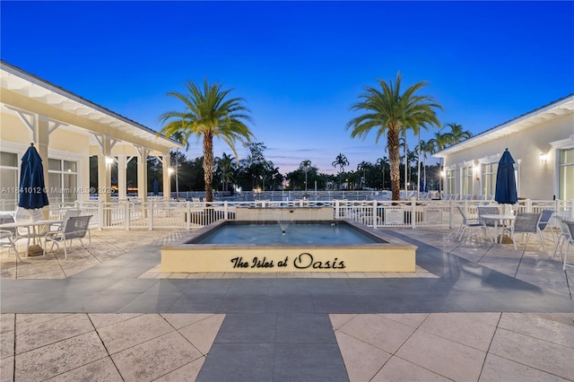 3135 NE 4th St, Homestead, FL 33033 - pool at dusk featuring a patio and a jacuzzi