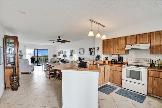 2215 Cypress Island Dr Unit 707, Pompano Beach, FL 33069 - kitchen with white electric range, a peninsula, open floor plan, light tile patterned flooring, and under cabinet range hood