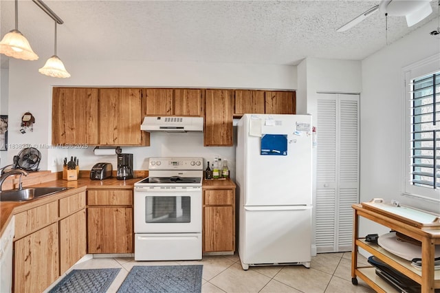 2215 Cypress Island Dr Unit 707, Pompano Beach, FL 33069 - kitchen featuring white appliances, a textured ceiling, ceiling fan, under cabinet range hood, and light tile patterned floors