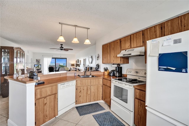 2215 Cypress Island Dr Unit 707, Pompano Beach, FL 33069 - kitchen with white appliances, a peninsula, a textured ceiling, light tile patterned floors, and open floor plan