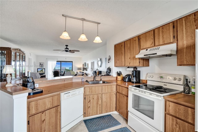 2215 Cypress Island Dr Unit 707, Pompano Beach, FL 33069 - kitchen with white appliances, a peninsula, open floor plan, under cabinet range hood, and light tile patterned flooring