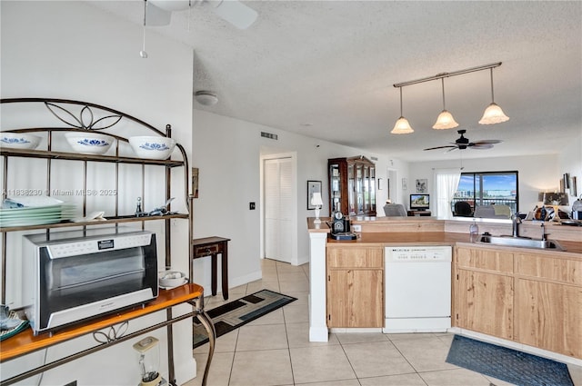 2215 Cypress Island Dr Unit 707, Pompano Beach, FL 33069 - kitchen with a ceiling fan, white dishwasher, light brown cabinetry, light tile patterned floors, and a textured ceiling