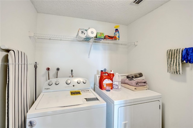 2215 Cypress Island Dr Unit 707, Pompano Beach, FL 33069 - laundry room with washer and dryer and a textured ceiling