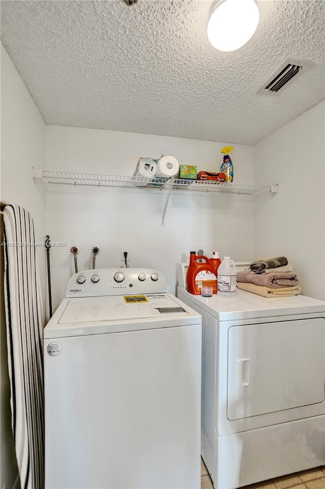 2215 Cypress Island Dr Unit 707, Pompano Beach, FL 33069 - washroom with separate washer and dryer and a textured ceiling