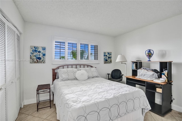 2215 Cypress Island Dr Unit 707, Pompano Beach, FL 33069 - bedroom with light tile patterned floors, a closet, and a textured ceiling