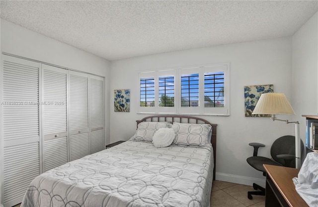 2215 Cypress Island Dr Unit 707, Pompano Beach, FL 33069 - tiled bedroom with a closet, a textured ceiling, and an office area