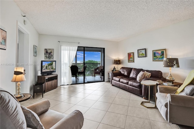 2215 Cypress Island Dr Unit 707, Pompano Beach, FL 33069 - living room featuring light tile patterned floors and a textured ceiling