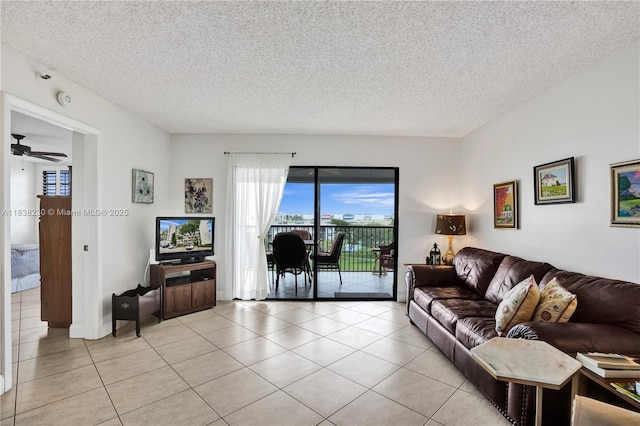 2215 Cypress Island Dr Unit 707, Pompano Beach, FL 33069 - living room with a textured ceiling, light tile patterned floors, and a ceiling fan