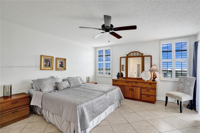 2215 Cypress Island Dr Unit 707, Pompano Beach, FL 33069 - bedroom featuring light tile patterned flooring, a textured ceiling, and ceiling fan