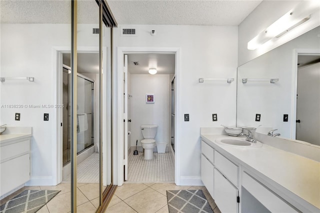 2215 Cypress Island Dr Unit 707, Pompano Beach, FL 33069 - full bath with vanity, a textured ceiling, a stall shower, and tile patterned floors