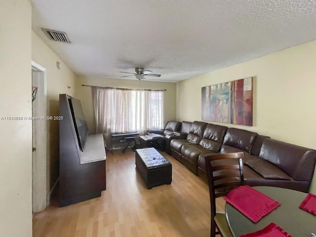 3276 NW 102nd Ter Unit 201-E, Coral Springs, FL 33065 - living room with ceiling fan, light wood finished floors, and a textured ceiling