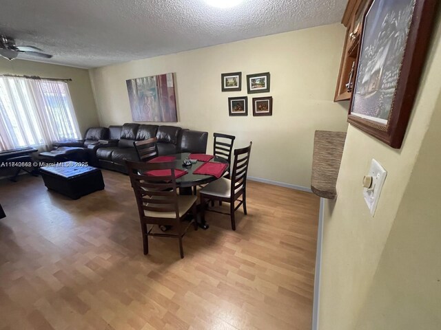 3276 NW 102nd Ter Unit 201-E, Coral Springs, FL 33065 - dining space with a textured ceiling and light wood-type flooring