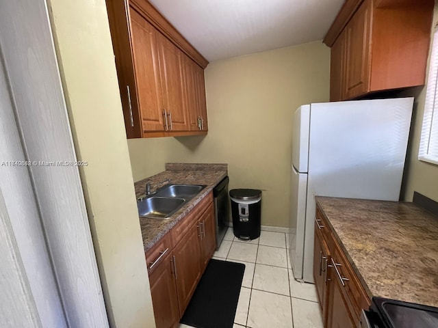 3276 NW 102nd Ter Unit 201-E, Coral Springs, FL 33065 - kitchen featuring freestanding refrigerator, range, brown cabinetry, dark countertops, and light tile patterned floors