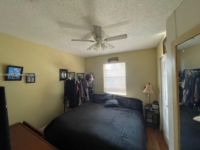 3276 NW 102nd Ter Unit 201-E, Coral Springs, FL 33065 - bedroom with wood finished floors, a textured ceiling, and a ceiling fan