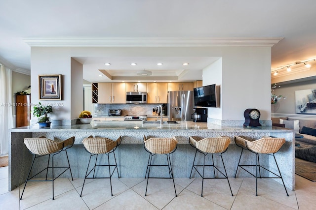4000 Towerside Ter Unit 1005, Miami, FL 33138 - kitchen with crown molding, a peninsula, decorative backsplash, appliances with stainless steel finishes, and light stone countertops